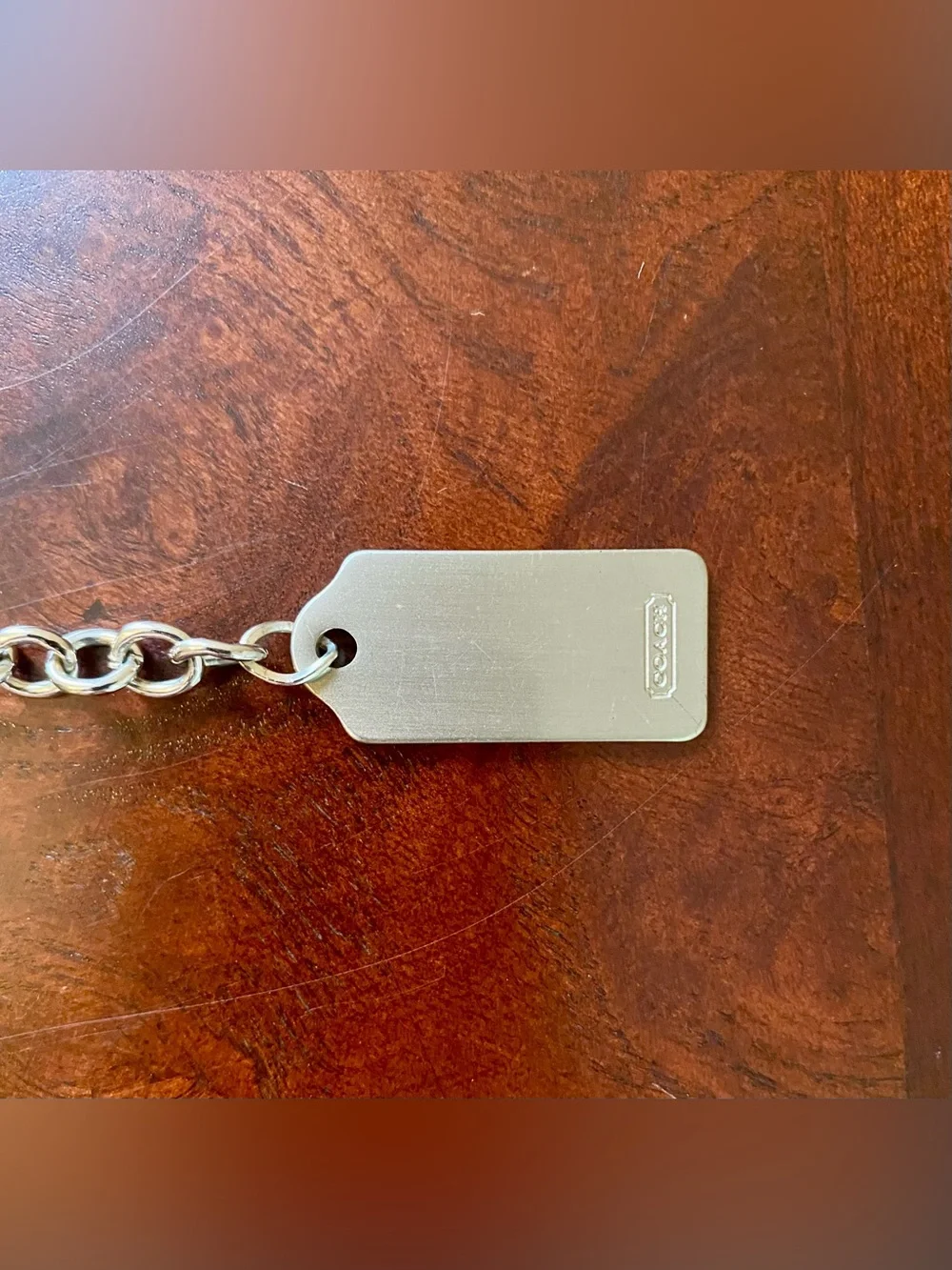 Coach metal tag